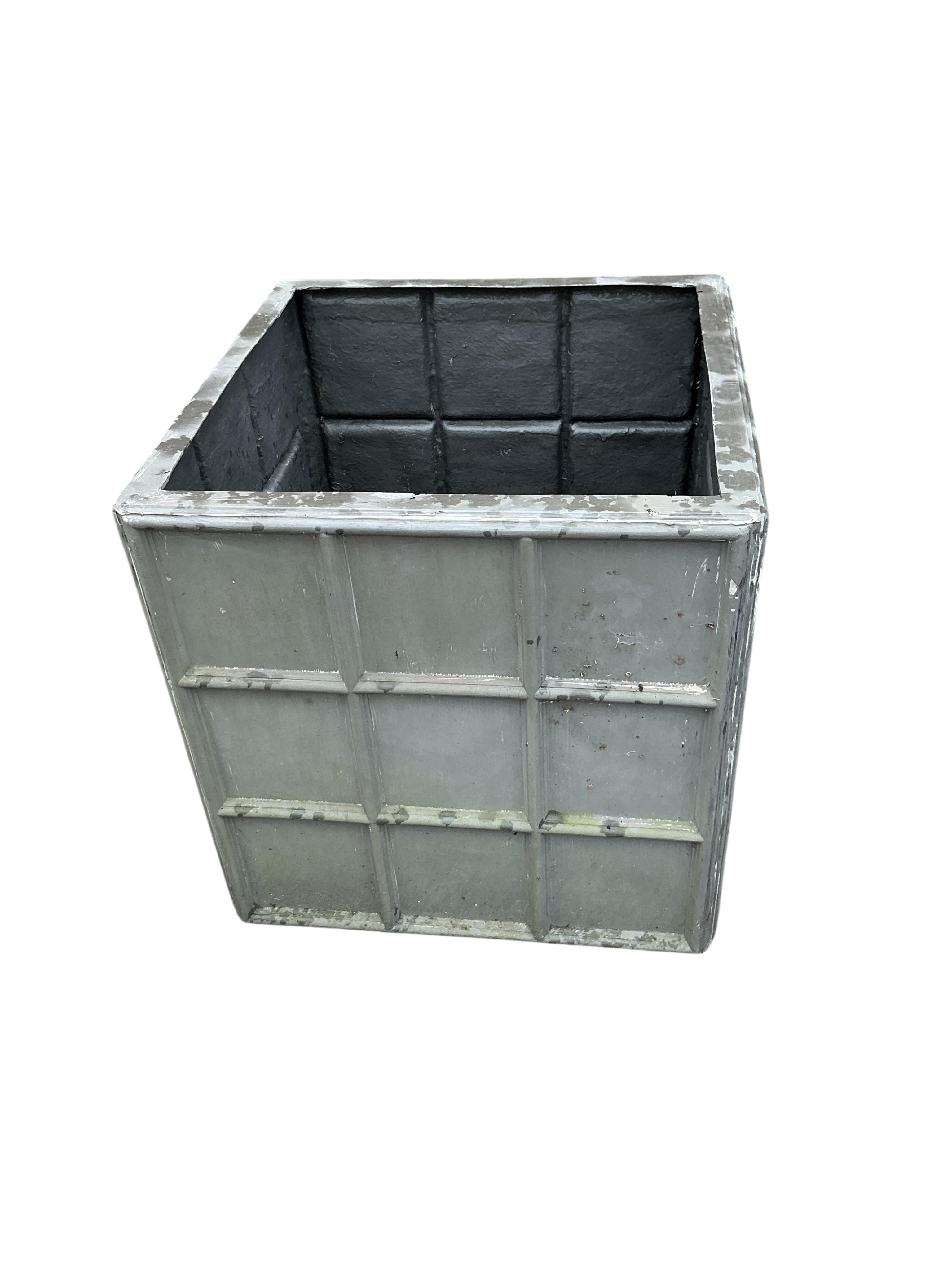 A pair of modern fibreglass faux lead garden planters, width 69cm, height 60cm